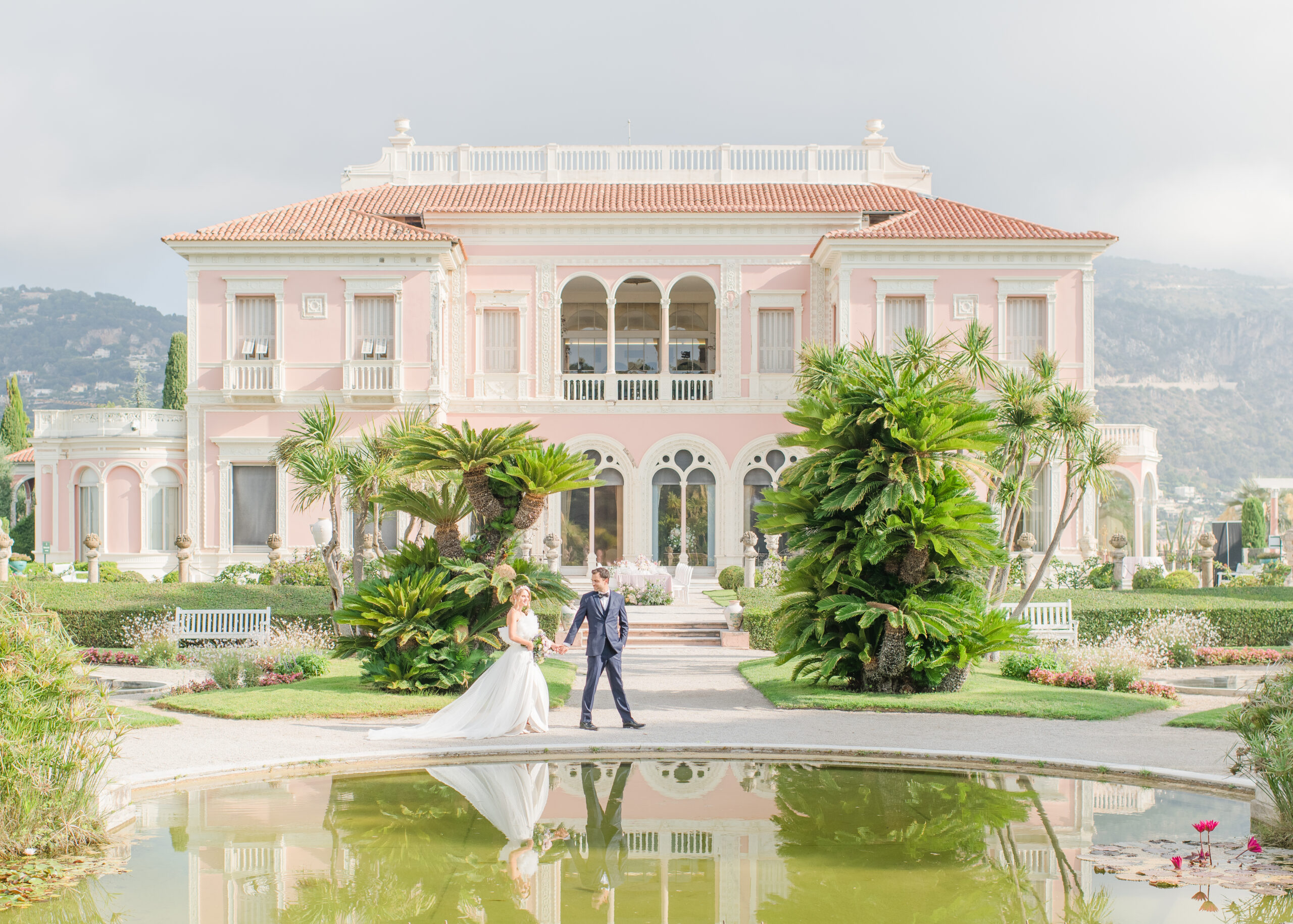 bride and groom walking in front of villa in france
