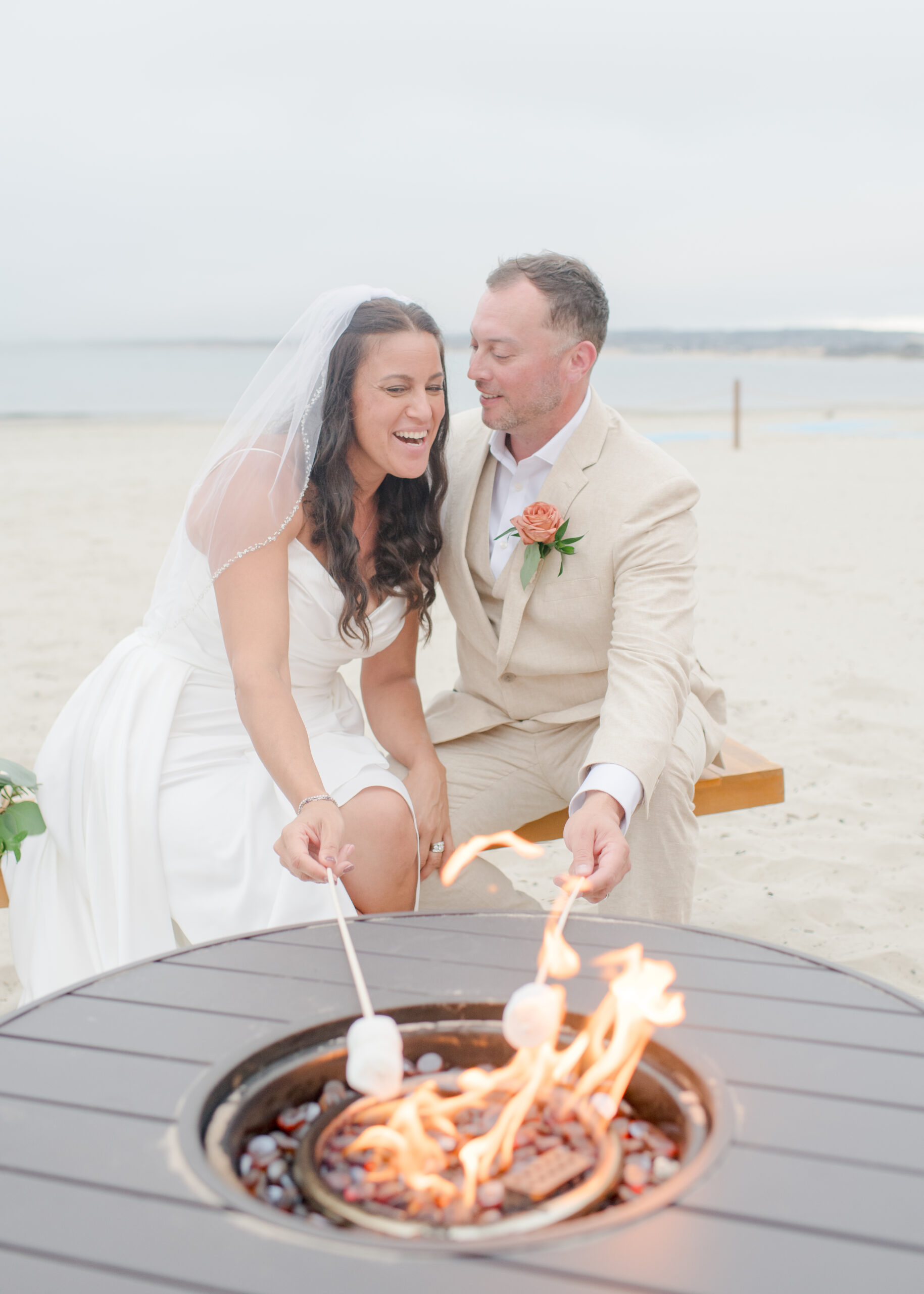 wedding couple roasting marshmallows on beach