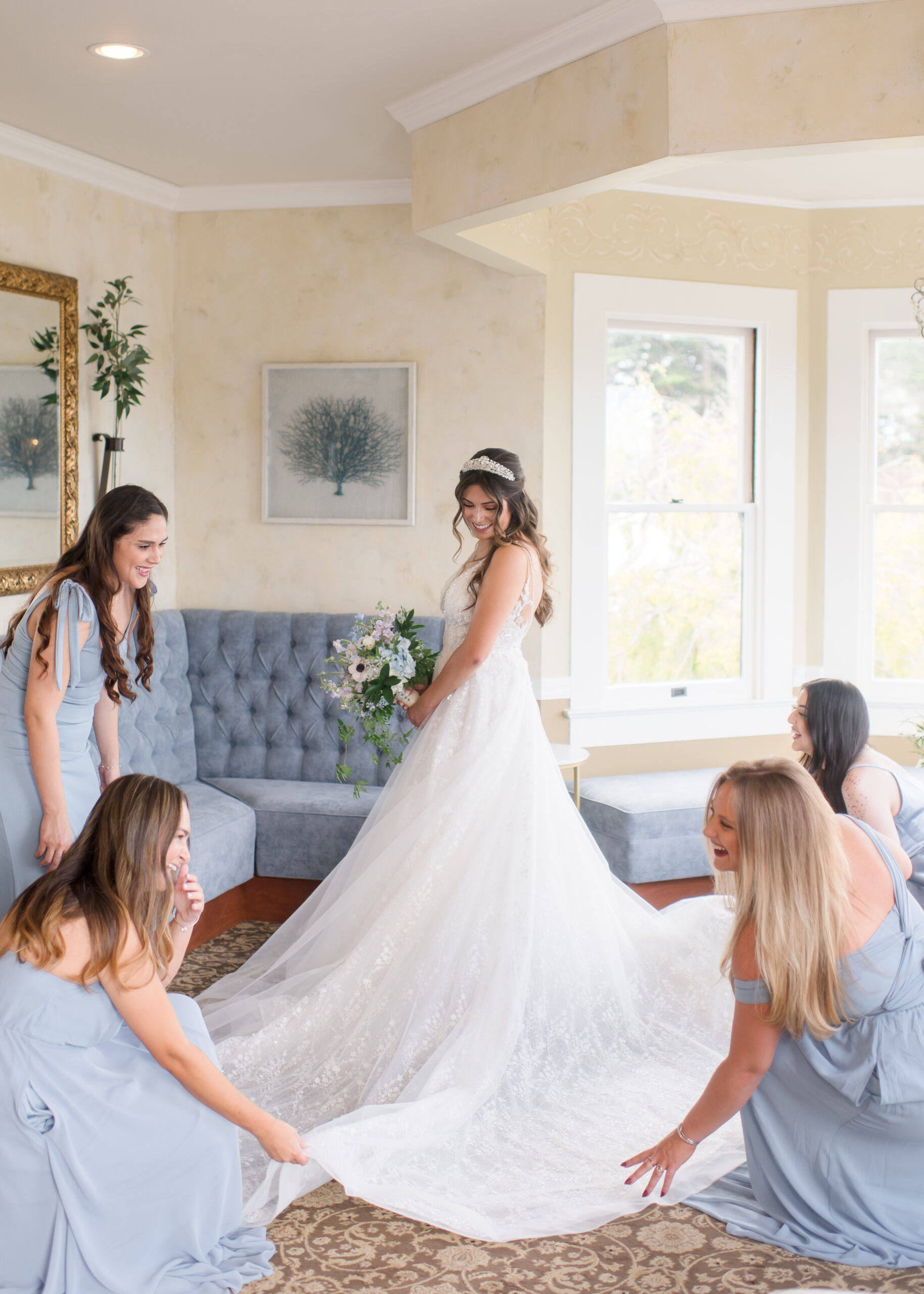 wedding party helping bride fluff dress