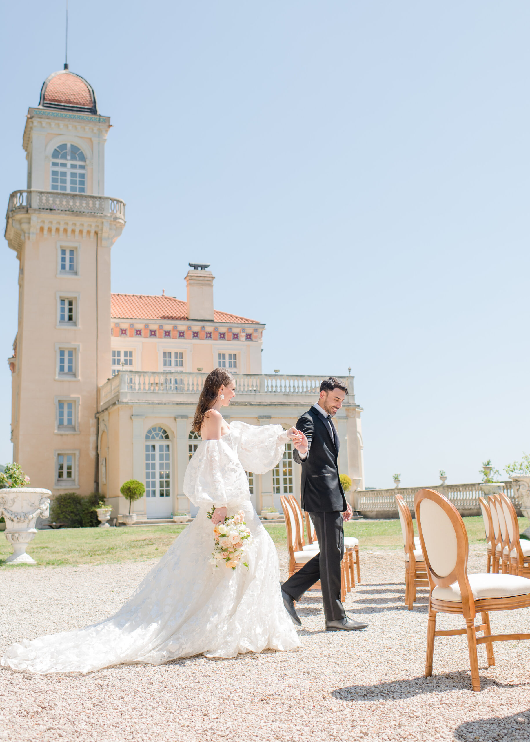 wedding couple walking in front of chateau in france