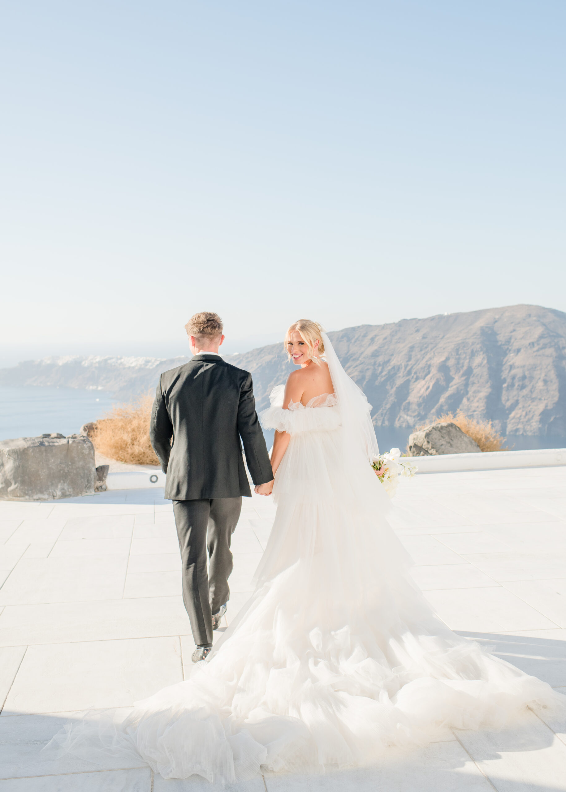 wedding couple walking away from the camera hand in hand at their destination wedding 