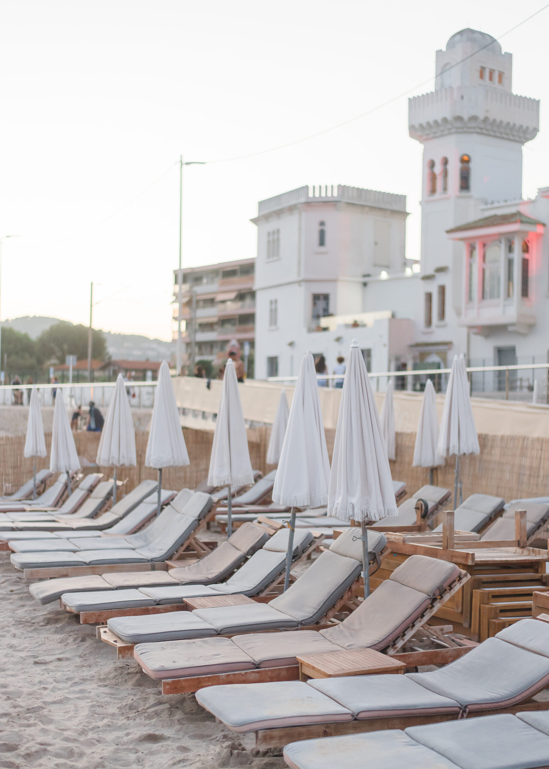 photo of white umbrellas and chairs at villa on the beach in france