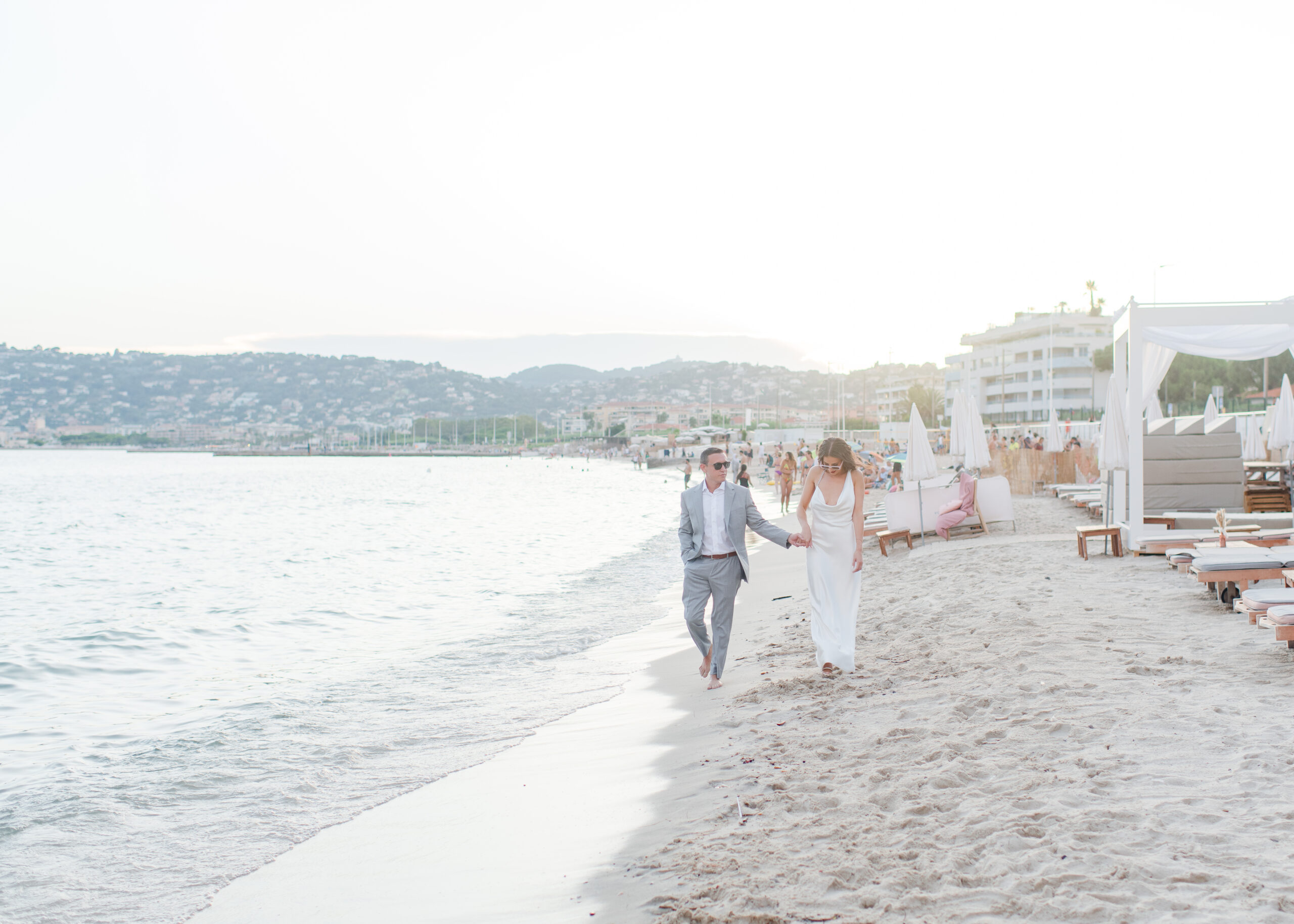 wedding couple walking on the beach at sunset