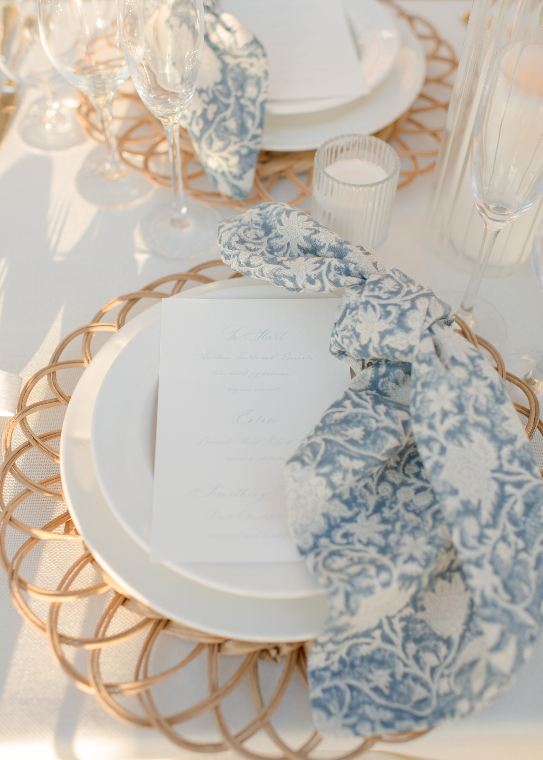 close up photo of blue and white napkin folded on place on wedding reception table