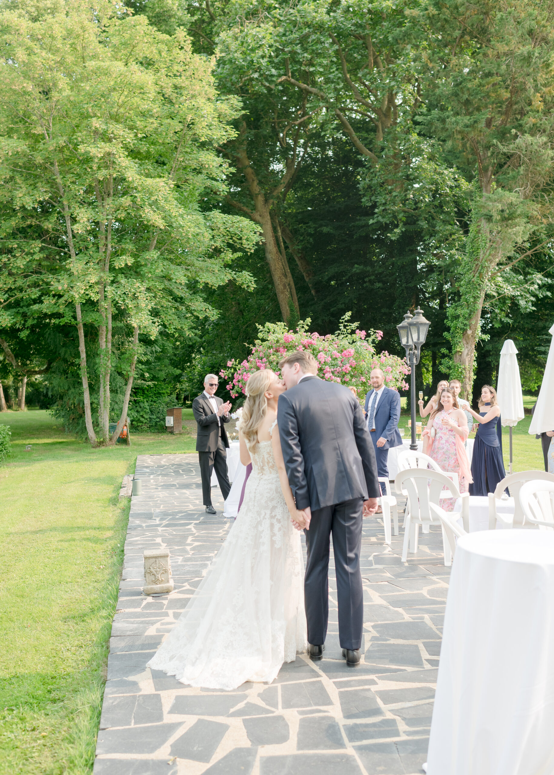 bride and groom kissing in front of guests 