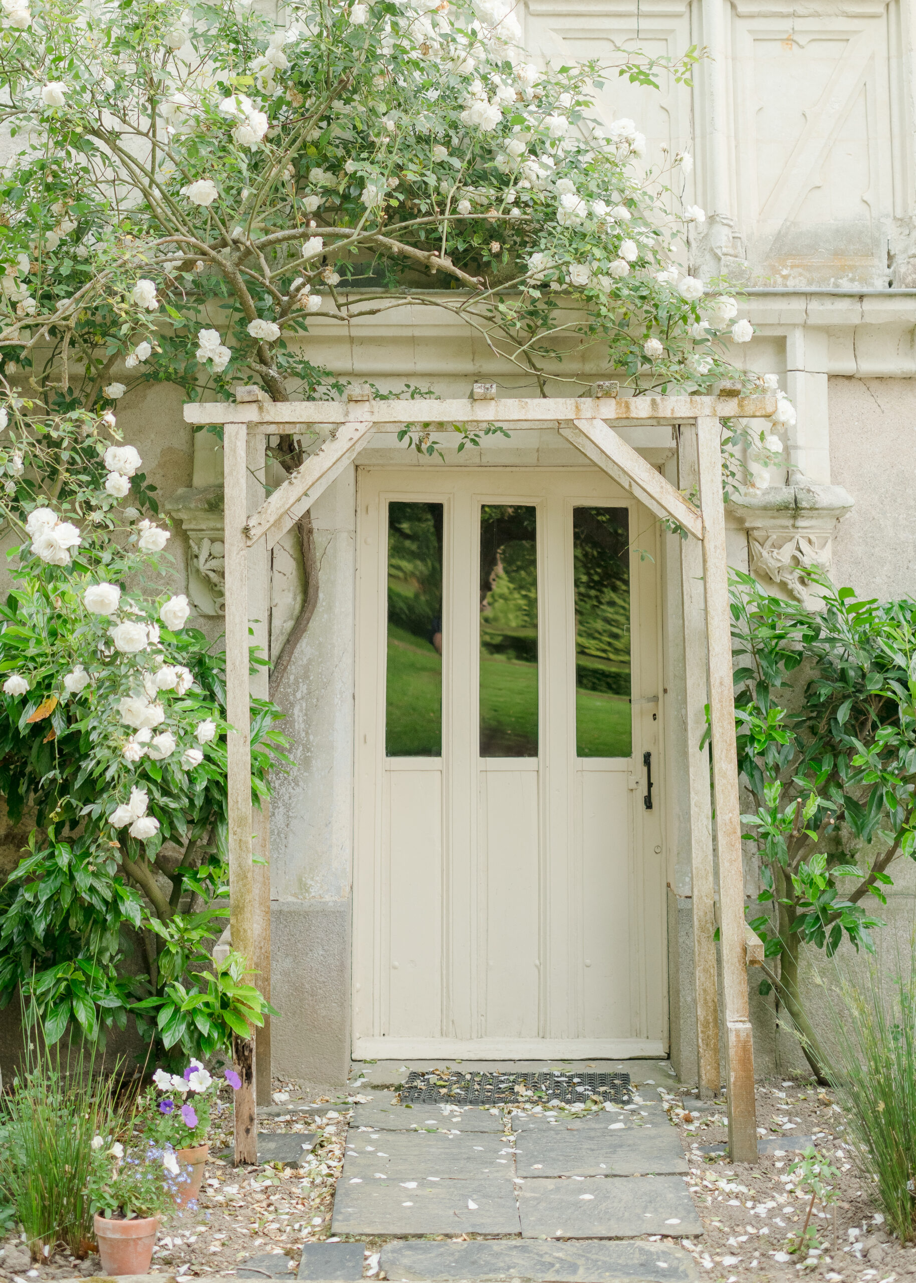 wooden door with white flowers around it.