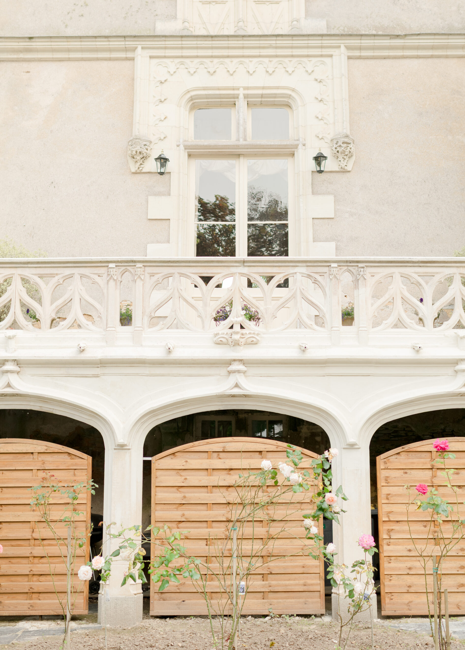terrace with brown doors and roses in garden
