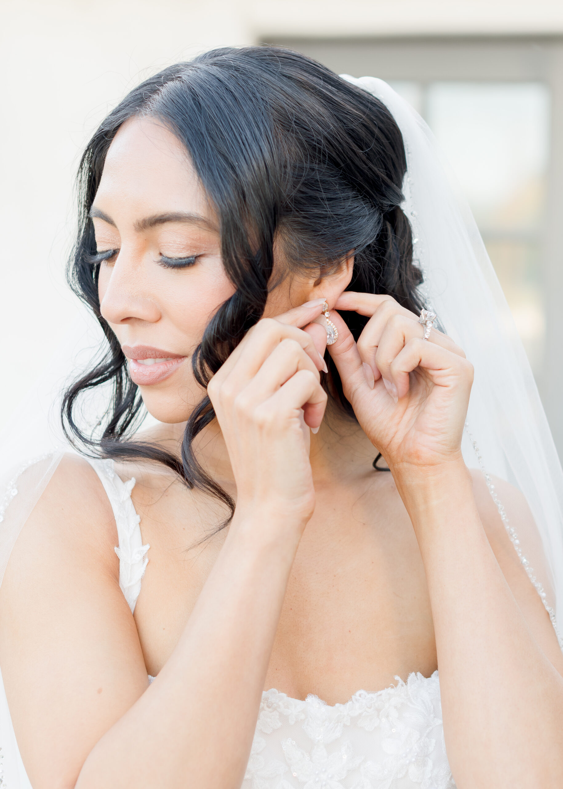 bride putting on earrings