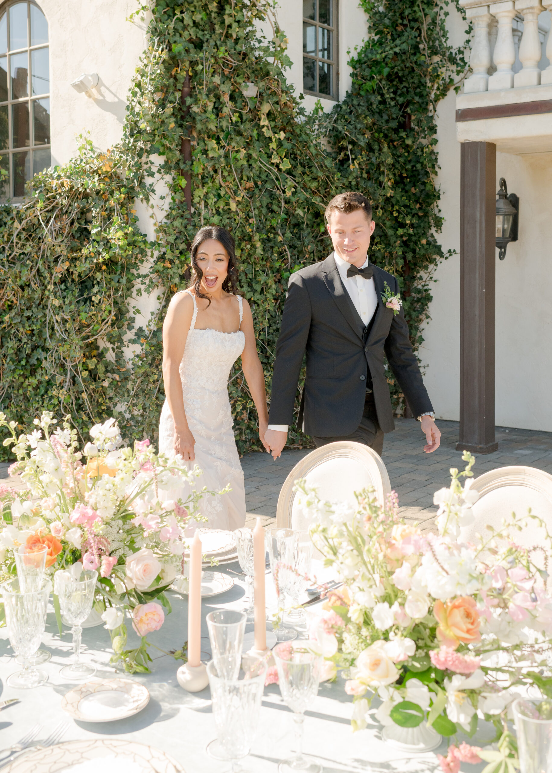 bride and groom looking at wedding reception table