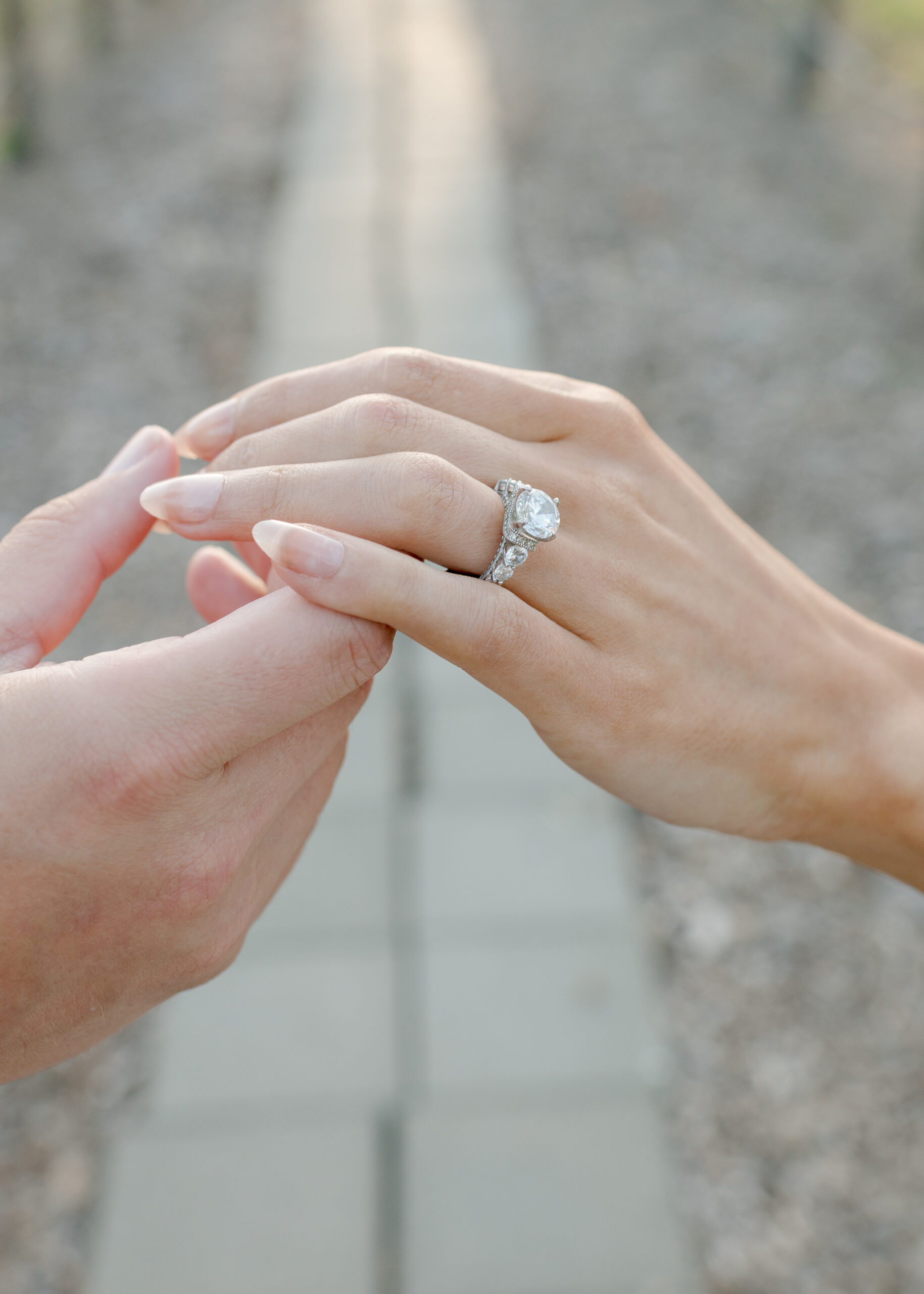 groom holding brides hand showing off ring.