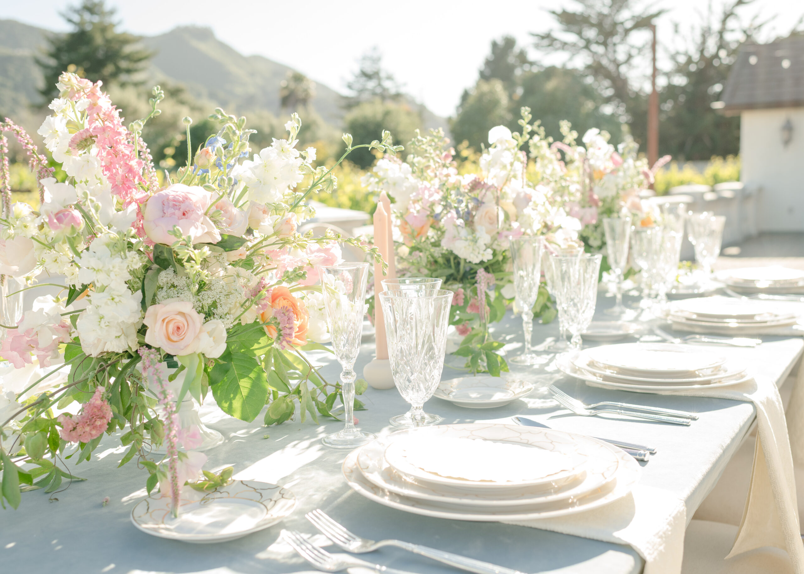 wedding table with blue linen and pastel flowers