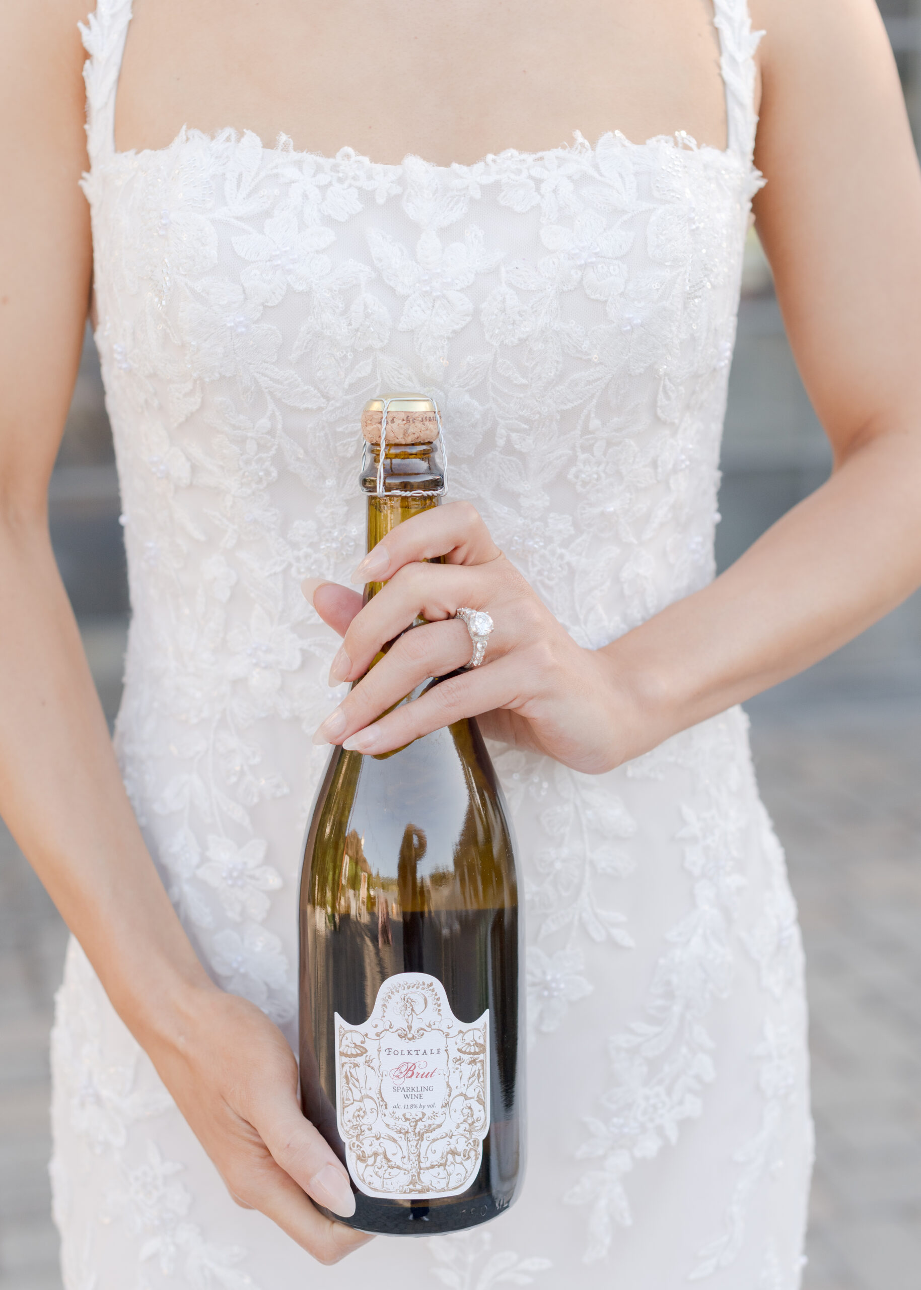 folktale winery wine bottle held by bride