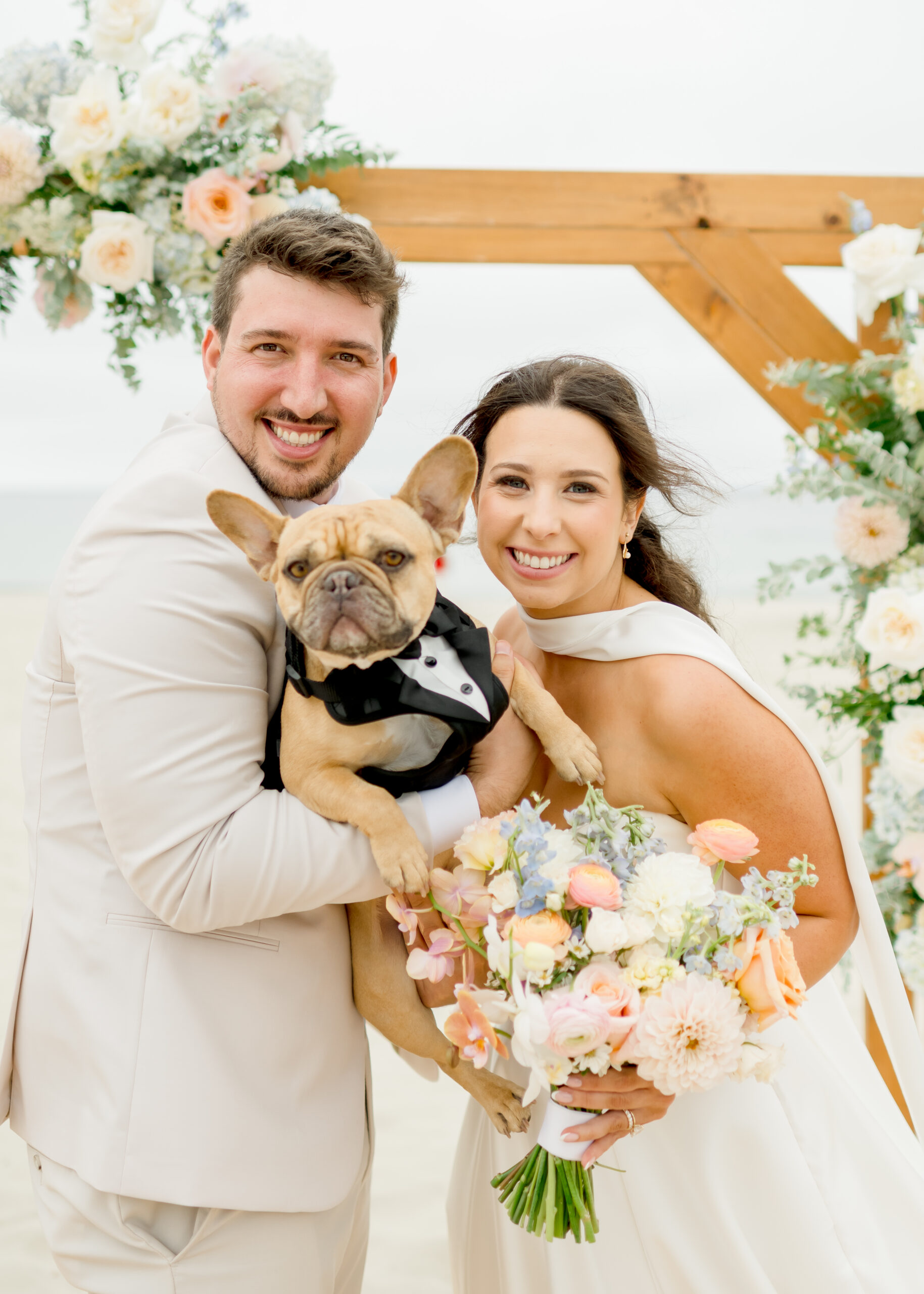 bride and groom with their frenchie dog