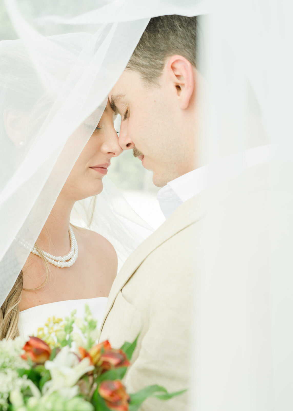 couple under veil at their north florida wedding
